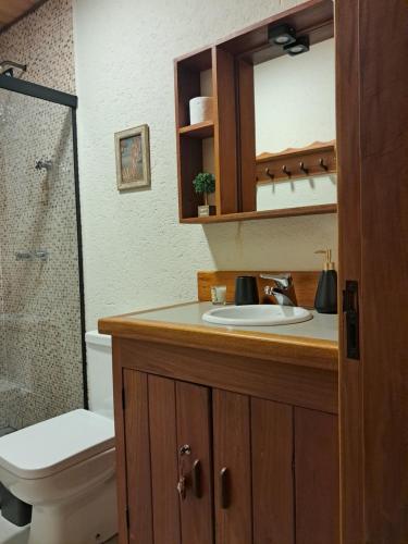 a bathroom with a sink and a toilet and a shower at Cabana do Sol -São Francisco Xavier in São José dos Campos