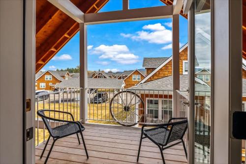 a porch with two chairs and a bike on it at Comfy & close to Lake Pend Oreille & Schweitzer in Dover