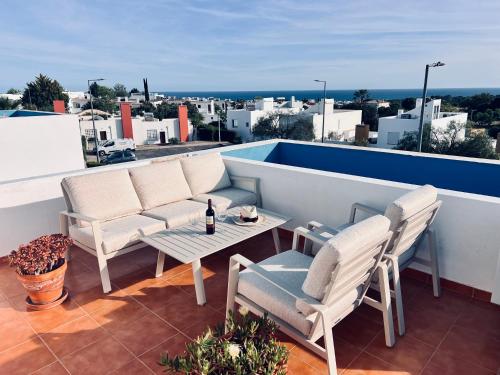 a patio with two chairs and a table on a roof at Casa Roxana in Porches
