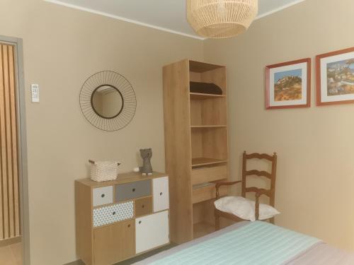 a bedroom with a bed and a dresser and a chair at U Muzzelo in Oletta