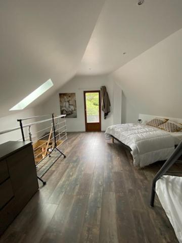 a bedroom with two beds and a dresser in a room at le lubermiga in Wimille