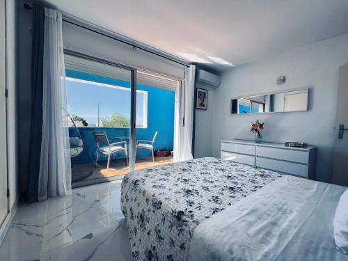 a bedroom with a bed and a large window at Casa Roxana in Porches