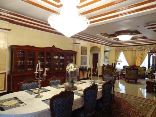 a dining room with a table and a chandelier at The Executive Villa Inn & Suites in Davao City