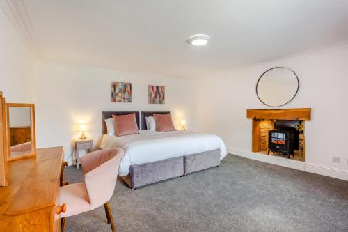 a bedroom with a bed and a mirror and a fireplace at 3 Bed in Kirriemuir oc-96450 in Kirriemuir