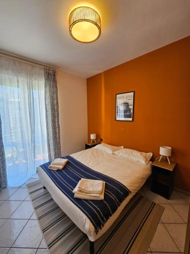 a bedroom with a large bed with orange walls at Apartment with a Mountain View in Lecco