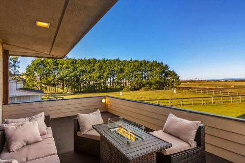 a balcony with two chairs and a table and a field at Spacious Gracious & Luxurious Retreat in Westport