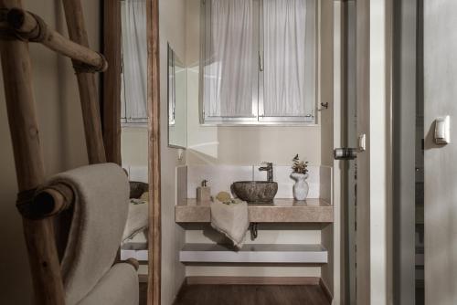 a bathroom with a sink and a mirror at Ederlezi Boutique Hotel in Athens