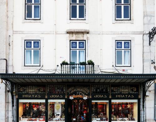 a store in front of a white building at Rossio Apartments in Lisbon