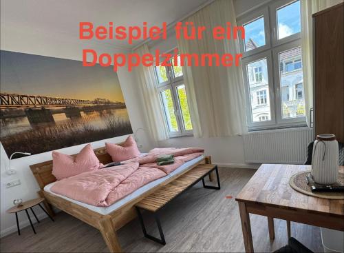 a bedroom with a bed with pink pillows at Downtown 38 in Wittenberge