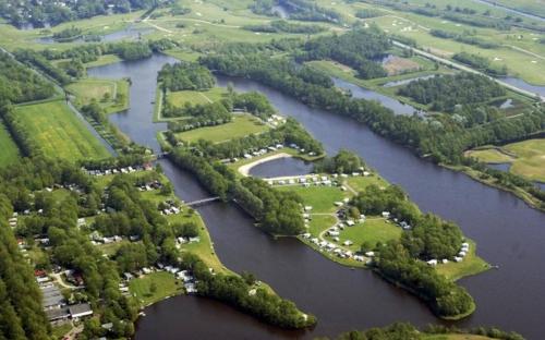 an aerial view of a group of trees in a river at Vakantiepark de Kleine Wielen in Leeuwarden