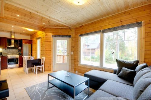 a living room with a couch and a table at Puttitie 4B in Tahkovuori