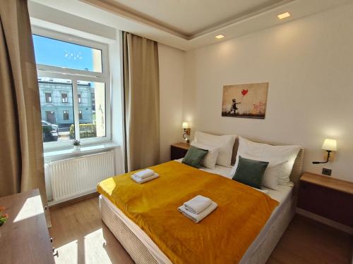 a bedroom with a large bed with two towels on it at Apartmány Promenáda in Trutnov