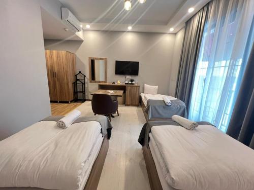 a hospital room with two beds and a desk at Baza Hotel Spa in Beylǝqan