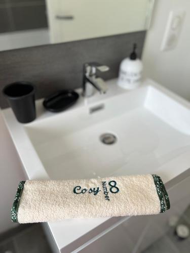 a towel on a bathroom sink with a coron eb on it at Cosynumber8 in Bar-sur-Seine
