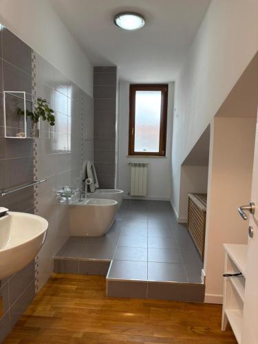 a white bathroom with a tub and a sink at MIALLEGRA Guest House in Bellona