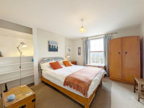 a bedroom with a large bed and a window at Gainsford - Arundel in Arundel