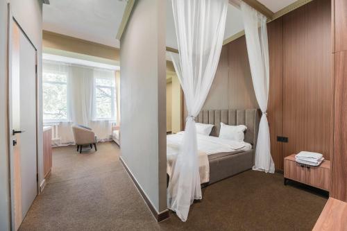 a hotel room with a bed and a mirror at UIDE Apart hotel in Almaty
