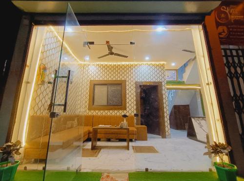 a living room with a couch and a table at shree krishna Hotel in Ujjain