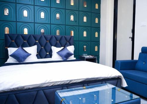 a blue bedroom with a bed and a blue chair at Hotel skyline in Visakhapatnam