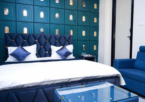 a blue bedroom with a bed and a blue chair at Hotel skyline in Visakhapatnam