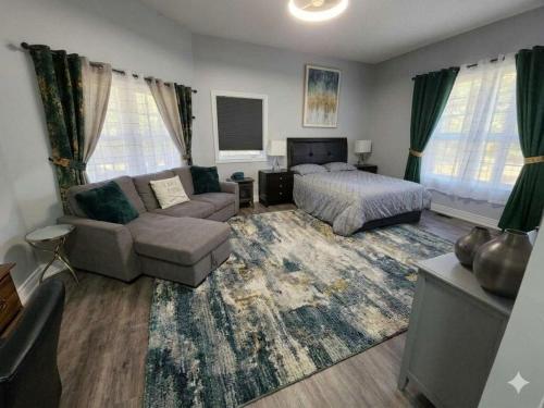 a living room with a bed and a couch at Lakefront Suite with Geodesic Dome Experience in Stouffville
