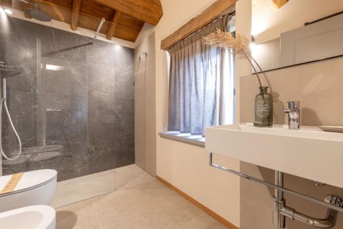 a bathroom with a shower and a toilet and a sink at Agriturismo Bramalpane in Bagno di Romagna
