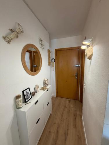 a bathroom with a mirror and a white dresser at Tamy-Home in Empuriabrava