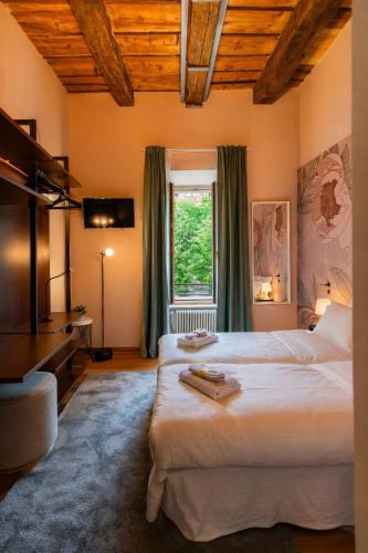 a bedroom with two beds and a window at Como Icon Centro Apartment By Icon7 Luxury in Como