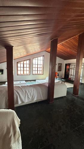 a bedroom with two beds and a wooden ceiling at Casa Aparecida in Aparecida