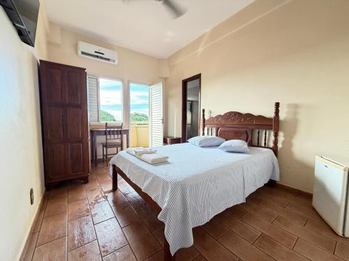 a bedroom with a bed and a table and chairs at Abaeté Palace Hotel in Abaeté