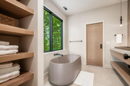 a white bathroom with a tub and a sink at Highpoint in New Plymouth