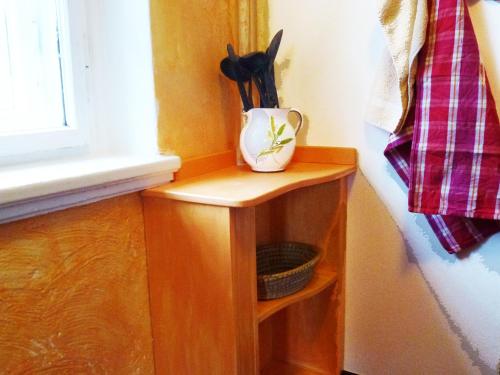 a vase sitting on a wooden shelf next to a window at Villa-Hufeland in Berlin