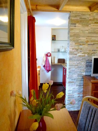 a kitchen with a table with a vase of flowers at Villa-Hufeland in Berlin