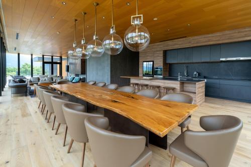a large dining room with a long table and chairs at Intuition in Kutchan