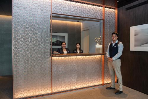 a man is standing in front of a mirror at Intuition in Kutchan
