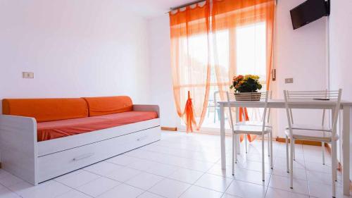 a living room with a couch and a table at Residenza Pierre & Vacances Luni Mare in Luni