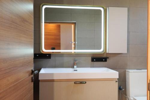 a bathroom with a sink and a mirror at villa Tarik with private pool in El Aïn