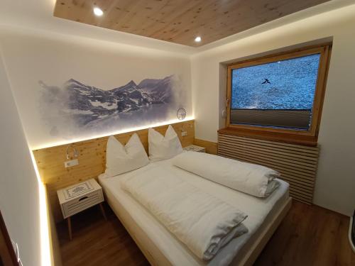 a bedroom with a bed with a large window at Landhaus Rieder in Mittersill