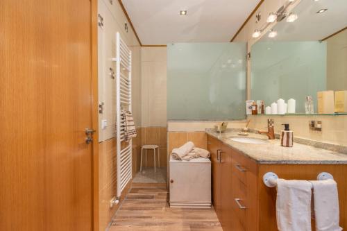 a bathroom with a sink and a large mirror at Casa Francisco y Carmen in Alfarrás