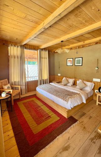 a bedroom with a large bed and a wooden ceiling at SAANJH, Shangarh in Shangarh