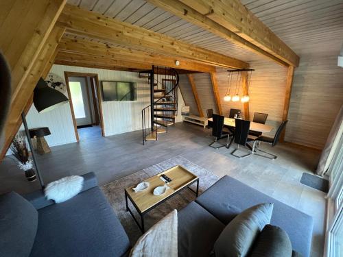 a living room with a blue couch and a table at Dachzelt Oase Damp in Damp
