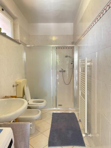 a bathroom with a shower and a toilet and a sink at Casa Mare Blu codice CITRA OO9O34 LT 1168 in Loano