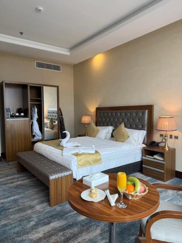a hotel room with a bed and a table at Karam Al Balad Hotel in Jeddah