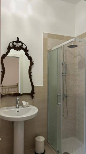 a bathroom with a sink and a glass shower at Lacerno Rooms in Pescosolido