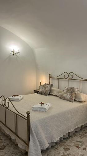 a bedroom with a large bed with two pillows at Lacerno Rooms in Pescosolido