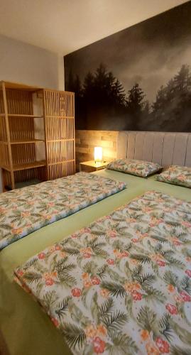 two beds in a bedroom with a painting on the wall at My Life 20 - Green Hill in Soko Banja