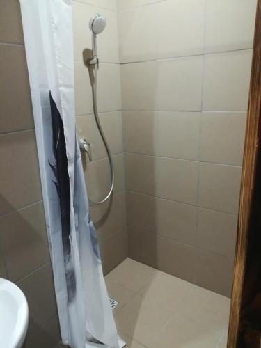 a shower with an umbrella in a bathroom at Hotel Garni in Liptovský Mikuláš