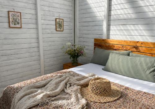 a bedroom with a bed with a hat on it at SleepOrup in Faxe