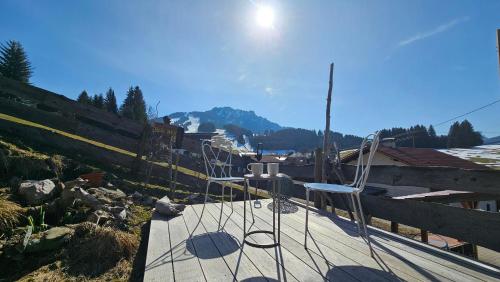 a couple of chairs sitting on top of a wooden deck at Jungholz Erlebnis in Jungholz