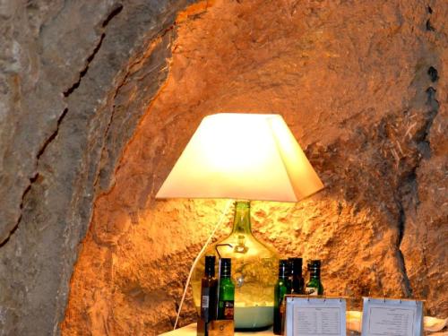 a lamp sitting on a table next to bottles at Cal Valeriet in Montsonis